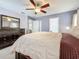 Spacious bedroom with ceiling fan, a dresser, and two entryways at 2530 Sandy Beach Ln, Clearwater, FL 33763