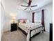 Bedroom features an iron bed frame and matching nightstand at 2530 Sandy Beach Ln, Clearwater, FL 33763