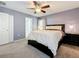 Bedroom with a ceiling fan, a nightstand and an adjoining bath at 2530 Sandy Beach Ln, Clearwater, FL 33763
