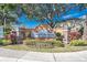 Welcome to the Sunset Pointe community, with lush landscaping and a welcoming sign for a picturesque entrance at 2530 Sandy Beach Ln, Clearwater, FL 33763