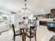 Open dining area with modern lighting fixtures, flowing into the kitchen and living area at 2530 Sandy Beach Ln, Clearwater, FL 33763