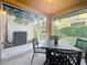 Enclosed lanai with roll down shades and patio seating at 2530 Sandy Beach Ln, Clearwater, FL 33763