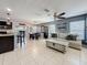 Open-concept living room and dining area features tile flooring and ample natural light at 2530 Sandy Beach Ln, Clearwater, FL 33763
