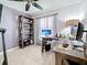 Well-lit home office with neutral colors, built in shelving and a ceiling fan at 2530 Sandy Beach Ln, Clearwater, FL 33763