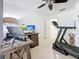 Well-lit home office with a treadmill and a door to another room at 2530 Sandy Beach Ln, Clearwater, FL 33763