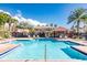 Community pool featuring plenty of lounge chairs and a nearby playground at 2530 Sandy Beach Ln, Clearwater, FL 33763