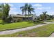 Well-maintained home with lush lawn and mature trees adding to the curb appeal at 2810 Doone Cir, Palm Harbor, FL 34684
