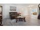 Bright living room with wood floors, cozy seating, and natural light streaming in at 2810 Doone Cir, Palm Harbor, FL 34684