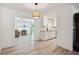 Living area view to kitchen and pool, showcases modern lighting and open layout at 2810 Doone Cir, Palm Harbor, FL 34684