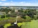 Aerial view of the community with a lake, pier and winding walking trails through the trees at 31970 Blue Passing Loop, Wesley Chapel, FL 33545