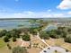 Aerial view of the community with a building, park, and scenic lake in the background at 31970 Blue Passing Loop, Wesley Chapel, FL 33545