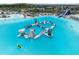 A serene lagoon with a water park, slides, and lounging area at 31970 Blue Passing Loop, Wesley Chapel, FL 33545