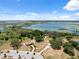 Aerial view of the community with a building, parking lot, and scenic lake in the background at 31970 Blue Passing Loop, Wesley Chapel, FL 33545