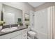 Clean bathroom featuring shower-tub, vanity with granite counter, and modern fixtures at 31970 Blue Passing Loop, Wesley Chapel, FL 33545