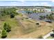 Aerial view of a fenced dog park with shelters and a parking lot, perfect for pet owners at 31970 Blue Passing Loop, Wesley Chapel, FL 33545