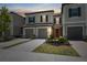 Charming two-story townhome with gray stucco, shutters, and attached garages at 31970 Blue Passing Loop, Wesley Chapel, FL 33545