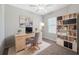 Home office with a desk, comfortable chair, bookshelf, and natural light, creating an ideal workspace at 31970 Blue Passing Loop, Wesley Chapel, FL 33545