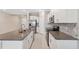 Modern kitchen featuring granite countertops, stainless steel appliances, and white cabinetry at 31970 Blue Passing Loop, Wesley Chapel, FL 33545