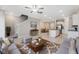Open-concept living room featuring tile floors, a cozy seating area, and seamless access to the kitchen at 31970 Blue Passing Loop, Wesley Chapel, FL 33545