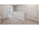 Loft area with neutral carpet and staircase at 31970 Blue Passing Loop, Wesley Chapel, FL 33545