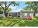 Expansive backyard featuring lush greenery and outdoor seating, perfect for relaxation and enjoying the outdoor ambiance at 3302 W Beaumont St, Tampa, FL 33611