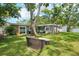 Spacious backyard with cozy outdoor seating area, perfect for enjoying sunny days and outdoor activities, with yellow door at 3302 W Beaumont St, Tampa, FL 33611