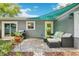 Inviting backyard patio with comfortable seating and grill, great for outdoor gatherings and relaxation, with yellow door at 3302 W Beaumont St, Tampa, FL 33611