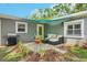 Cozy backyard patio with outdoor furniture, perfect for enjoying sunny days and outdoor relaxation, with yellow door at 3302 W Beaumont St, Tampa, FL 33611