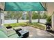 Charming backyard patio with stylish outdoor furniture, ideal for relaxation and entertaining guests, under a shade sail at 3302 W Beaumont St, Tampa, FL 33611