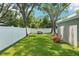 Picturesque backyard with lush lawn and mature trees, perfect for relaxation and outdoor enjoyment at 3302 W Beaumont St, Tampa, FL 33611