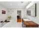 Well-lit bathroom with a stylish vanity, soaking tub, and modern decor, leading to a hardwood floor bedroom at 3302 W Beaumont St, Tampa, FL 33611