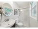 Bright bathroom with a modern shower, sink and an eye-catching oval mirror at 3302 W Beaumont St, Tampa, FL 33611