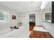 Well-lit bathroom with a stylish vanity, soaking tub, and modern decor, leading to a hardwood floor bedroom at 3302 W Beaumont St, Tampa, FL 33611
