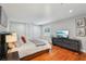 Spacious bedroom featuring hardwood floors, a comfortable bed, and built in wardrobes at 3302 W Beaumont St, Tampa, FL 33611