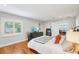 Bedroom featuring hardwood floors, plantation shutters, modern media center, and stylish décor at 3302 W Beaumont St, Tampa, FL 33611