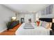 Bedroom with hardwood floors, a comfortable bed, and view into the hallway and office at 3302 W Beaumont St, Tampa, FL 33611