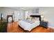 Well-lit bedroom featuring hardwood floors, a comfortable bed, and stylish furnishings at 3302 W Beaumont St, Tampa, FL 33611