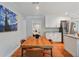 Dining room with hardwood floors leading into the kitchen; stylish artwork provides a focal point at 3302 W Beaumont St, Tampa, FL 33611
