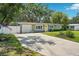 Attractive single-story home with a beautiful yard, garage, and vibrant yellow front door at 3302 W Beaumont St, Tampa, FL 33611