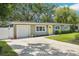 Charming single-story home with a well-manicured lawn and bright yellow front door at 3302 W Beaumont St, Tampa, FL 33611