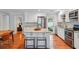 Updated kitchen featuring white cabinets, stainless steel appliances, and central island with barstool seating at 3302 W Beaumont St, Tampa, FL 33611