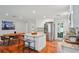 Bright kitchen with white cabinetry, stainless steel appliances, island seating, and hardwood floors at 3302 W Beaumont St, Tampa, FL 33611