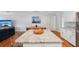 Kitchen featuring an island with granite countertops, seamlessly connected to the living room at 3302 W Beaumont St, Tampa, FL 33611