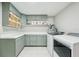 Well-organized laundry room with ample counter space, modern appliances, and stylish cabinetry, offering convenience and functionality at 3302 W Beaumont St, Tampa, FL 33611