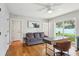 Bright home office featuring hardwood floors, a comfortable sofa, and a window overlooking the yard at 3302 W Beaumont St, Tampa, FL 33611