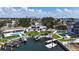 Aerial view of property with dock, pool, waterfront, tiki hut, and city skyline at 3436 Manatee Se Dr, St Petersburg, FL 33705