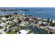 Aerial view of waterfront neighborhood featuring homes with pools and boat docks, offering coastal living at 3436 Manatee Se Dr, St Petersburg, FL 33705