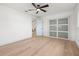 Bright bedroom with wood floors, a modern ceiling fan, closet and fresh paint at 3436 Manatee Se Dr, St Petersburg, FL 33705