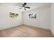 Bright bedroom with wood floors, two windows, a modern ceiling fan and fresh paint at 3436 Manatee Se Dr, St Petersburg, FL 33705