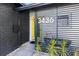 Stylish home entrance with decorative screen, bright yellow door, and modern address numbers at 3436 Manatee Se Dr, St Petersburg, FL 33705